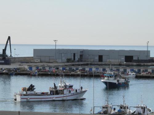 two boats are docked in the water in a harbor at BYPILLOW Mumm in Vilanova i la Geltrú