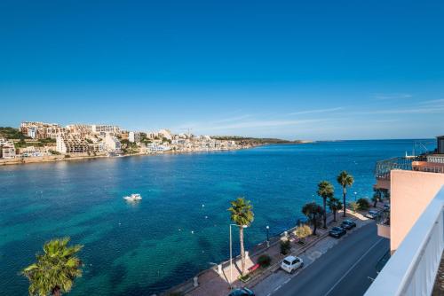 a view of a body of water with a city at Blue Harbour Seafront 3 bedroom apartment, with spectacular sea views from terrace - by Getawaysmalta in St. Paul's Bay