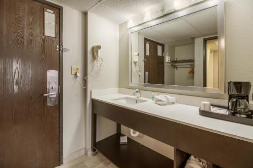 a bathroom with a sink and a mirror at Clarion Hotel Jackson Northwest in Jackson