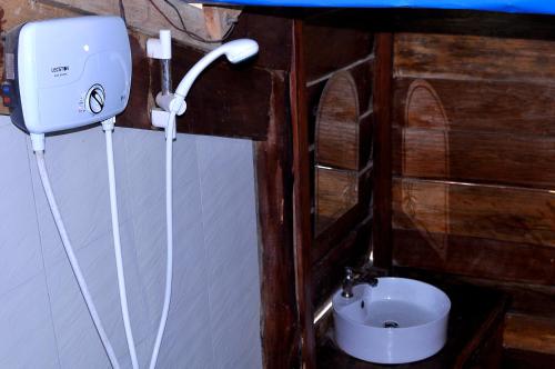 a small bathroom with a toilet and a sink at Happy Elephant Bungalows in Koh Rong Island