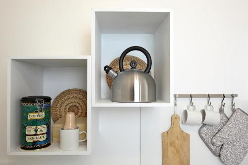 a cupboard with a tea kettle in it at Dimora Acanto in Bari