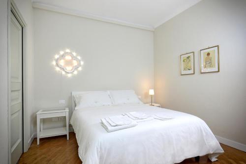 a bedroom with a white bed with two towels on it at Dimora Acanto in Bari