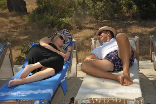 a man and a woman laying on beds at MARIMAR - Apartments OTRANTO in Otranto