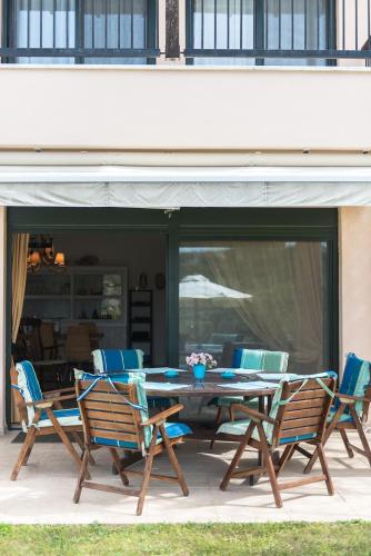 a wooden table and chairs on a patio at Villa Helios in Pefkochori