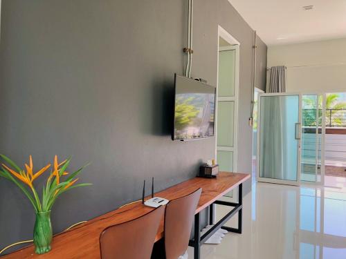 a dining room with a wooden table and chairs at Siya Private Pool Villa Ao Nang in Ao Nang Beach