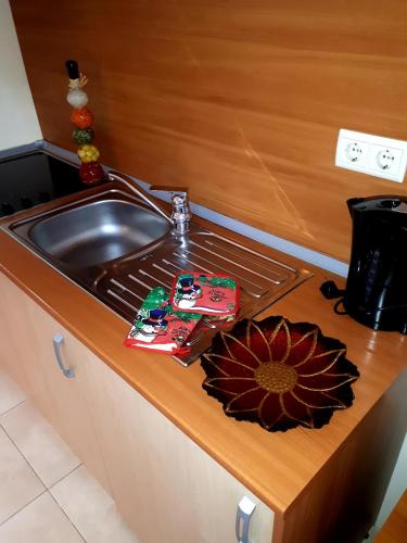 a kitchen counter with a sink and a sunflower on it at Enjoy Studios and Lovely Apartment Villa Park in Borovets