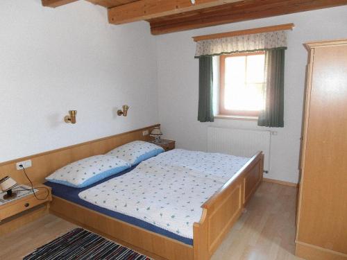 a small bedroom with a bed and a window at Bauernhof Hatzlhof in Schöder