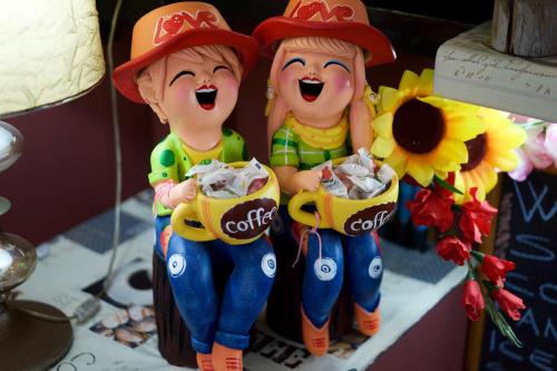 two toy figurines of two people eating popcorn at Kata Guesthouse Tuscany in Kata Beach