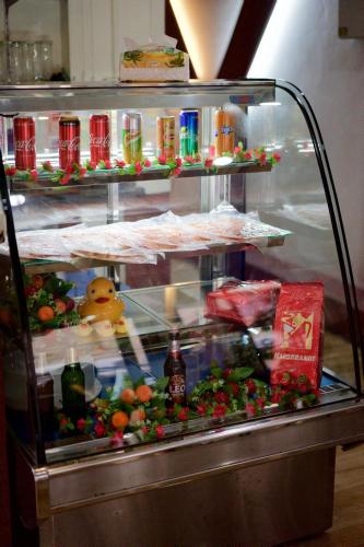 a refrigerator with food and drinks in it at Kata Guesthouse Tuscany in Kata Beach