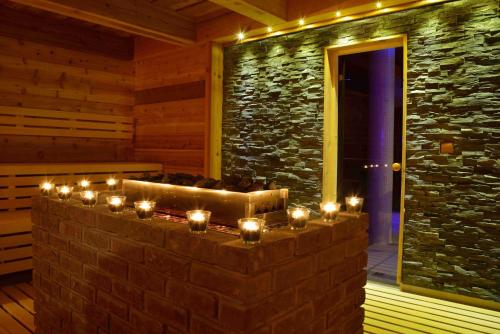 a room with a stone wall with candles in it at Hotel Palcát in Tábor
