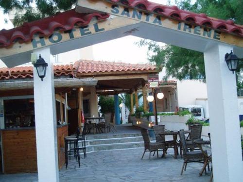 a patio with chairs and a sign for a restaurant at Santa Irene in Sougia
