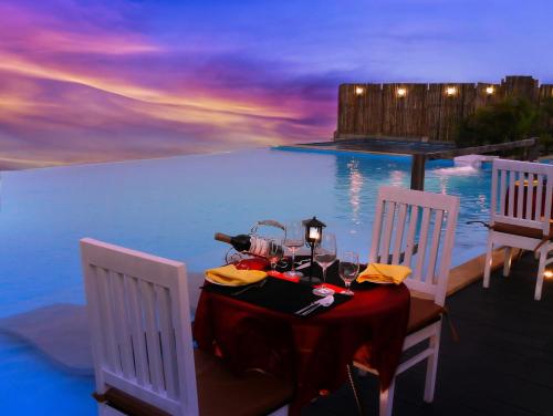a table and two chairs next to a pool at Polo Cherrapunjee Resort in Cherrapunji