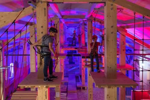 a group of people standing in a room with purple lights at Hostel & Pension Alte Brauerei in Eisenach