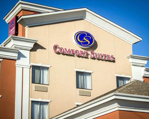 a building with a sign for a convention suites at Comfort Suites Sanford in Sanford