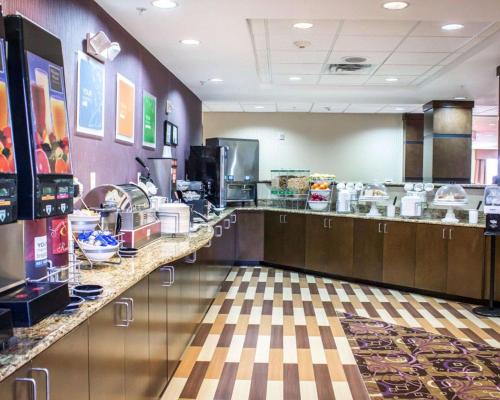 a restaurant kitchen with a counter top with food at Comfort Suites Sanford in Sanford