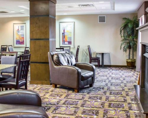 a waiting room with a couch and chairs at Comfort Suites Sanford in Sanford