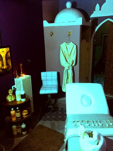 a room with a bed and a dress on a dummy at Hotel Vents Des Iles in Essaouira