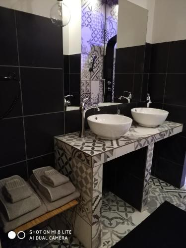a bathroom with two sinks on a marble counter at Oasi in Kato Loutraki