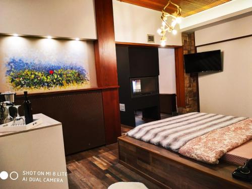 a room with a bed and a painting on the wall at Oasi in Kato Loutraki