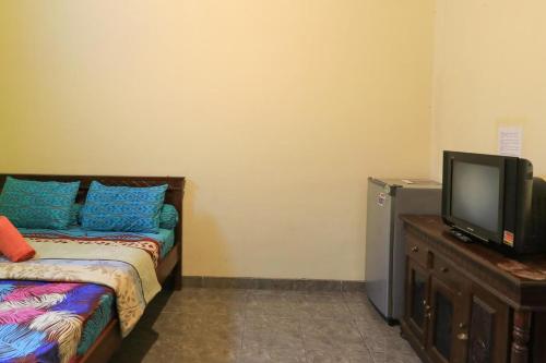 Кровать или кровати в номере Kubu Turah Homestay
