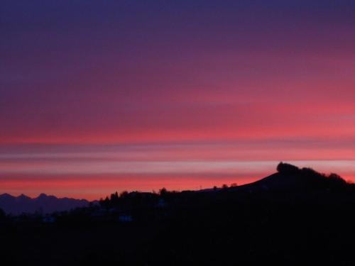 a sunset over a mountain with a red sky at Agriturismo La Casa Nei Boschi in Colderù