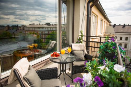 a balcony with a table and two glasses of wine at Hotel Rival in Stockholm