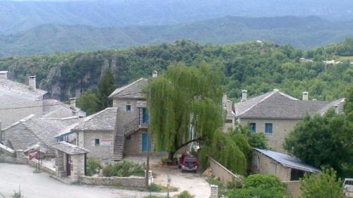 a group of houses with mountains in the background at Hotel Ladias in Monodendri