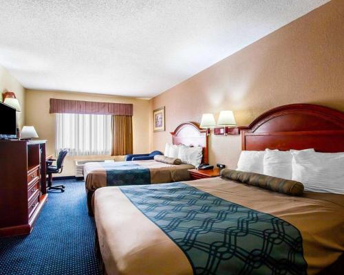 a hotel room with two beds and a television at Econo Lodge - Prattville in Prattville