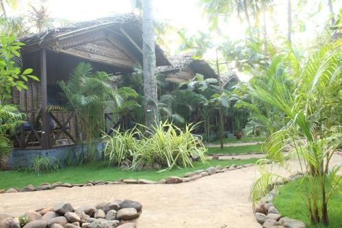 a house with a path in front of it at Sea Shades Palolem Resort in Palolem