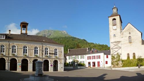 a large building with a tower and a church at lecurieabedous in Bedous