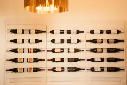 a display of wine bottles on a wall at Agriturismo Cozzo di Papaleo in Ragusa