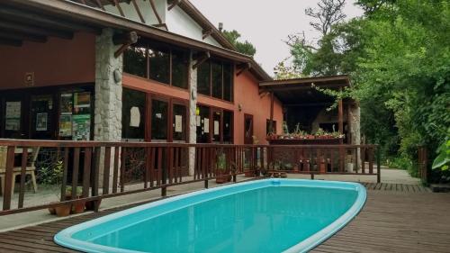 a swimming pool on a deck next to a building at Complejo Casa Caracolnegro in Mar de Cobo
