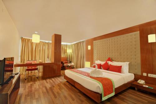 A bed or beds in a room at Monarch Luxur - Infantry Road