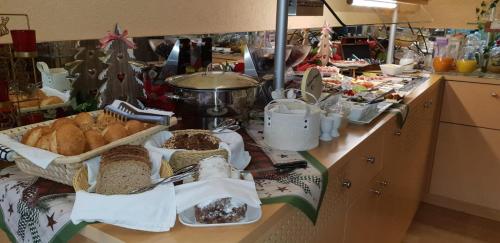 a buffet with bread and pastries on a counter at Sevda's Hotel Garni Weinforth in Willingen
