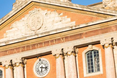 a building with a clock on the front of it at Hôtel Innes by HappyCulture in Toulouse