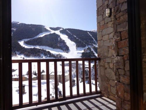 a balcony with a view of a snow covered mountain at Apartamentos Grifo Vacances Julia in El Tarter