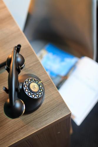 a telephone sitting on top of a table at Hôtel Innes by HappyCulture in Toulouse