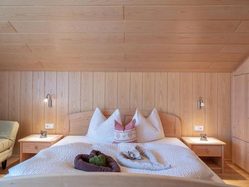 a bedroom with two people laying on a bed at Marenklhof in Tesido