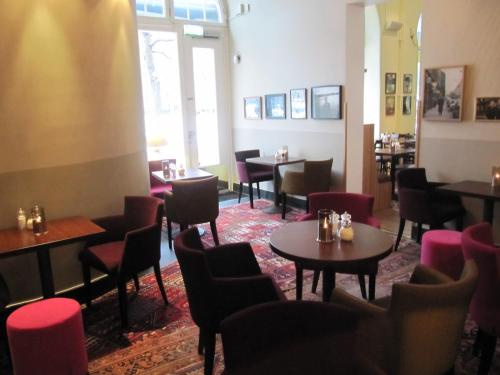 a restaurant with tables and chairs in a room at Hotel Rival in Stockholm