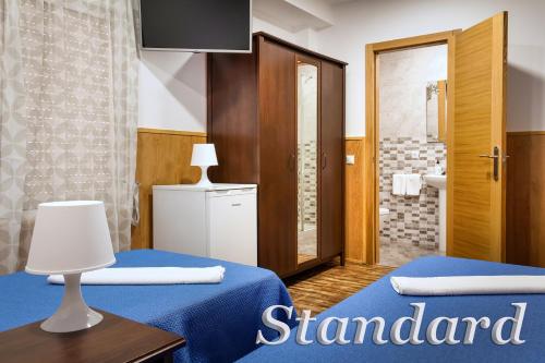 a hotel room with two beds and a bathroom at Irati in Benidorm