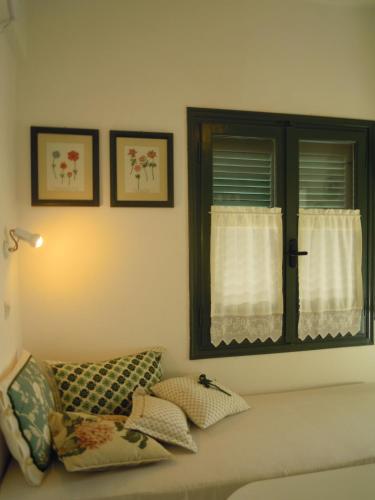 a living room with a couch and a window at Palemilos Apartments in Elounda