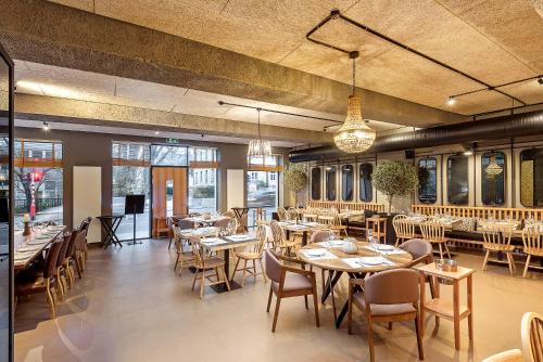 a restaurant with tables and chairs in a room at Vistay apartments in Luxembourg