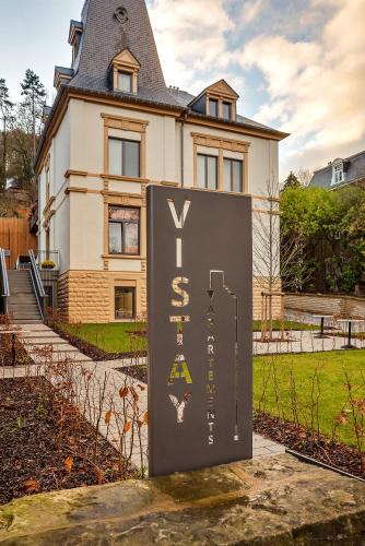 a house with a sign in front of it at Vistay apartments in Luxembourg