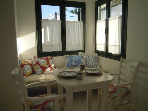 a living room with a table and a couch at Palemilos Apartments in Elounda