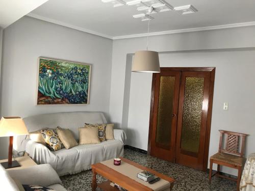 a living room with a couch and a table at Bonito piso en el centro de Benaguacil in Benaguacil