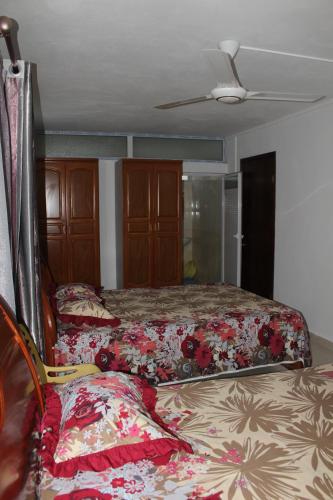 a bedroom with two beds and a ceiling at Bano Beach Residence - Grand Bay Beach in Grand Baie