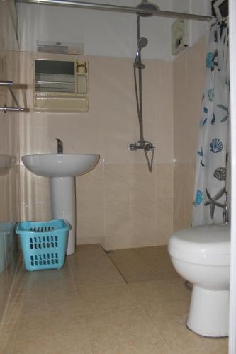 a bathroom with a sink and a toilet at Bano Beach Residence - Grand Bay Beach in Grand Baie