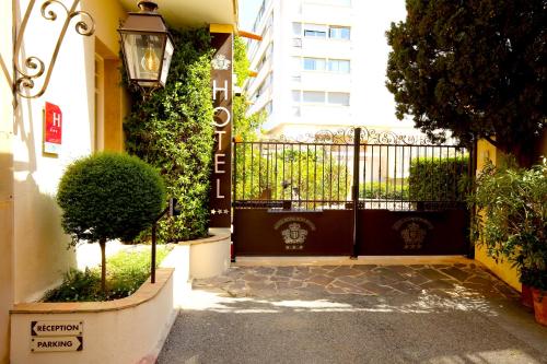 a black gate in front of a building at Hotel Royal Bon Repos in Sainte-Maxime