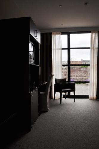 TV a/nebo společenská místnost v ubytování Hotel Boomgaard