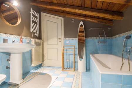 a bathroom with a tub and a sink and a bath tub at Papavero Accademia Carrara in Bergamo